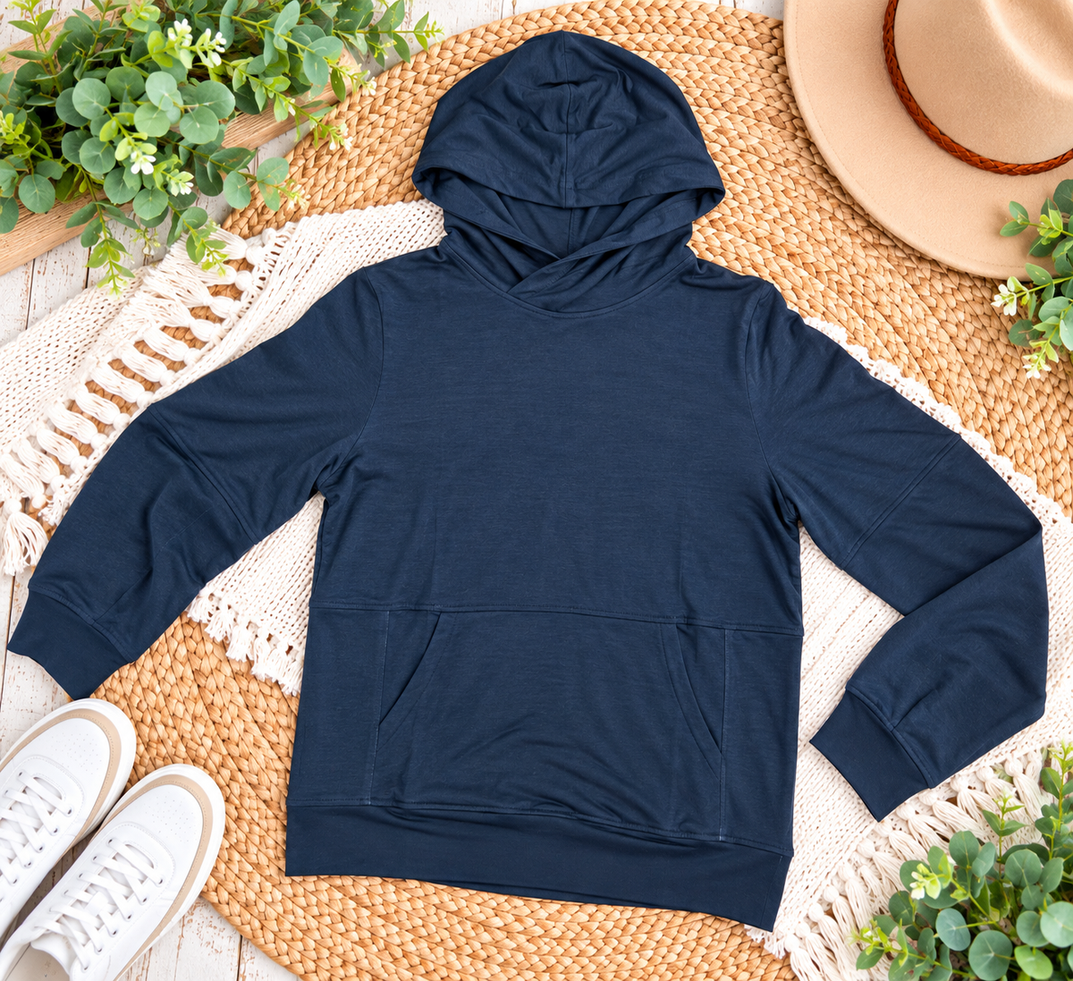 a blue hoodie on a woven mat