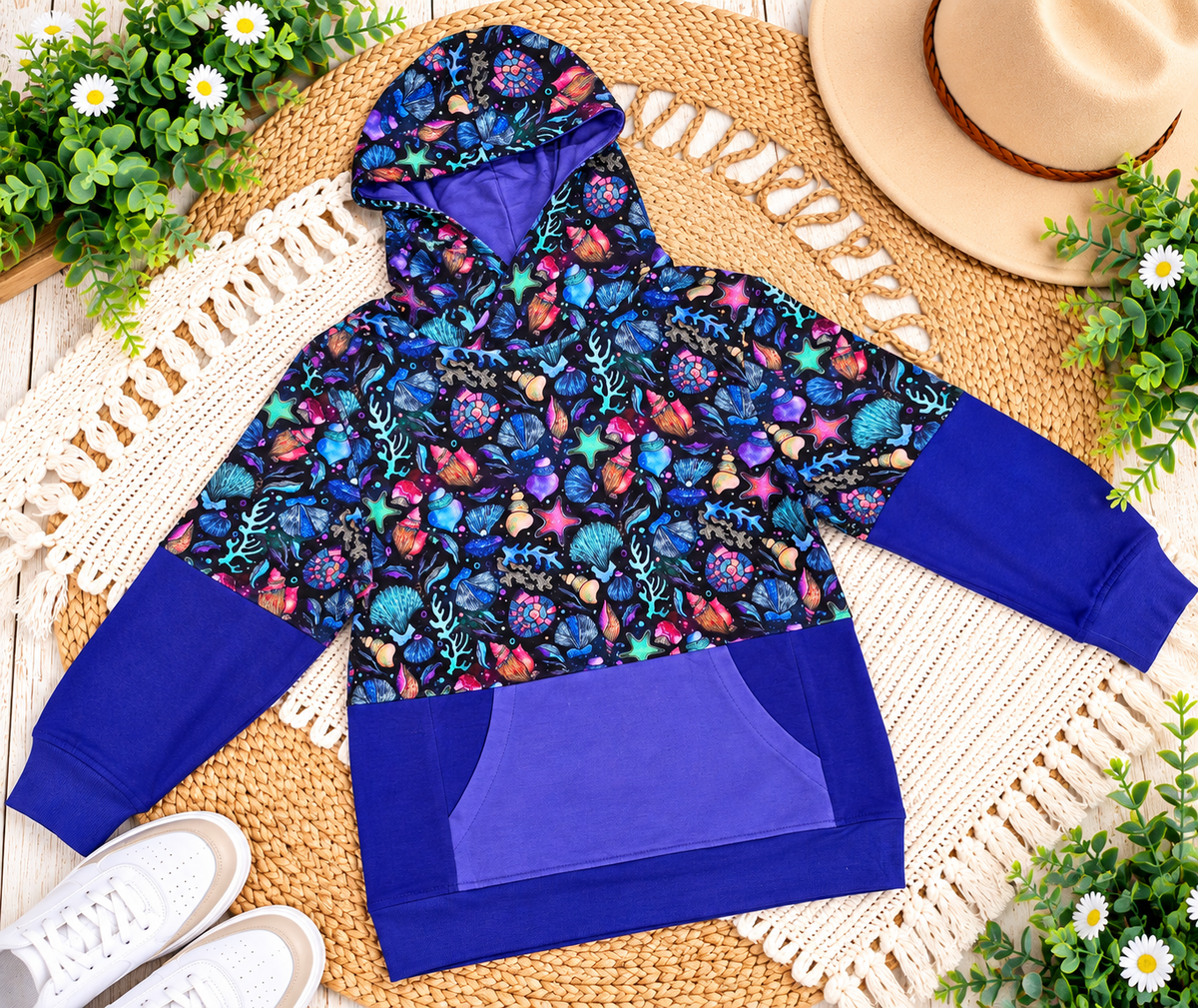 a blue and purple hoodie with a hat and flowers