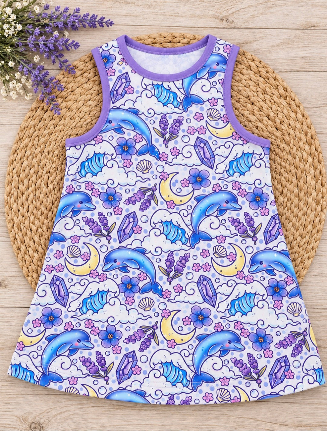 a dress with dolphins and flowers on a round mat