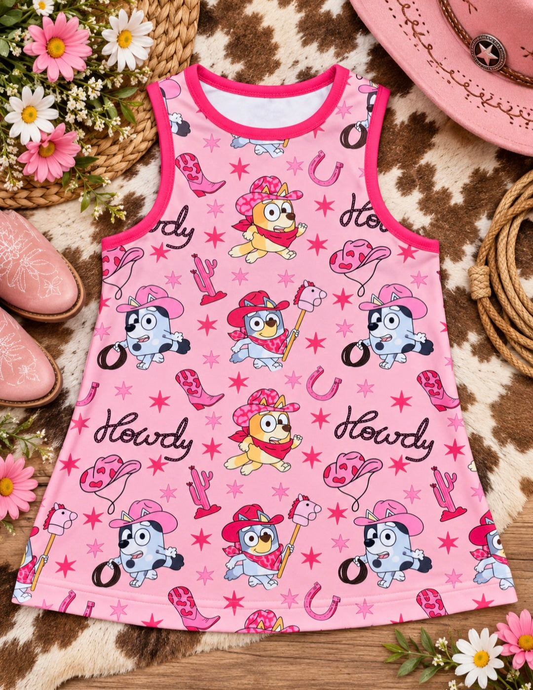 a pink dress with cartoon characters on it