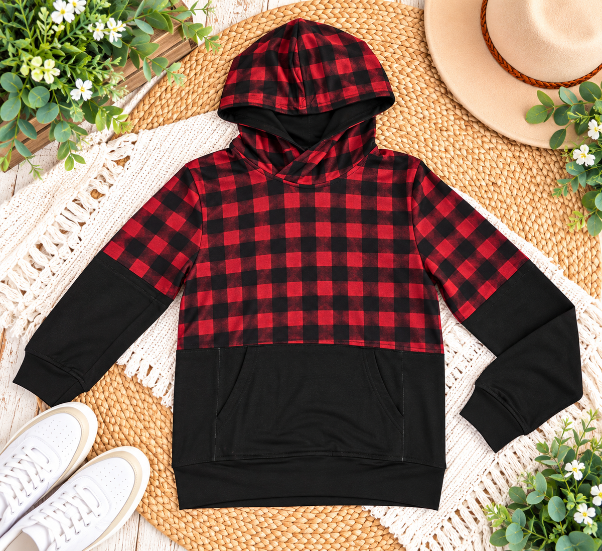 a red and black plaid hoodie on a rug