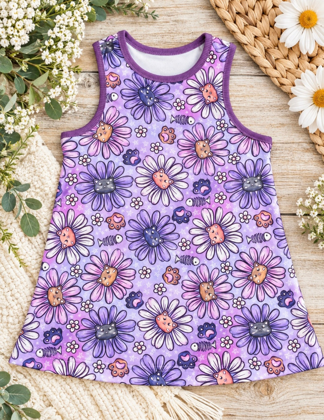 a purple tank top with flowers on it